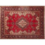 Hand made Iranian carpet with stylised floral pattern onto a red and blue ground, 354cm x 254cm :For