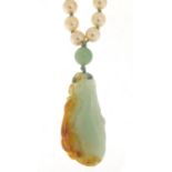 Chinese jade pendant carved with a dragon on a jade and simulated pearl necklace, 5cm high and 7.0cm