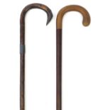 Two walking sticks comprising one with horn handle and a bamboo example with silver mounts, the