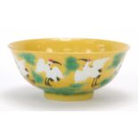 Chinese porcelain yellow and aubergine bowl hand painted with cranes amongst clouds above crashing