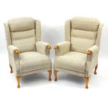 Pair of wingback armchairs with beige upholstery, raised of cabriole legs, 110cm high