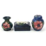 Moorcroft pottery comprising jar with cover, vase and box with cover, each hand painted with