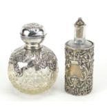 Henry Matthews, two Edwardian silver overlaid cut glass scent bottles embossed with Putti and