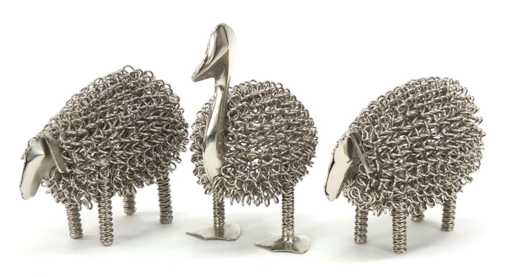 Three white metal animals comprising two sheep and a duck the largest 14cm high :For Further