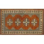 Rectangular Persian rug having a floral border onto orange grounds, 303cm x 131cm :For Further