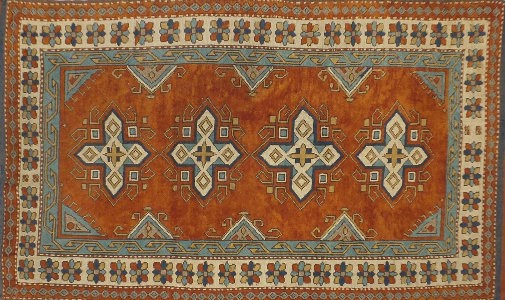 Rectangular Persian rug having a floral border onto orange grounds, 303cm x 131cm :For Further