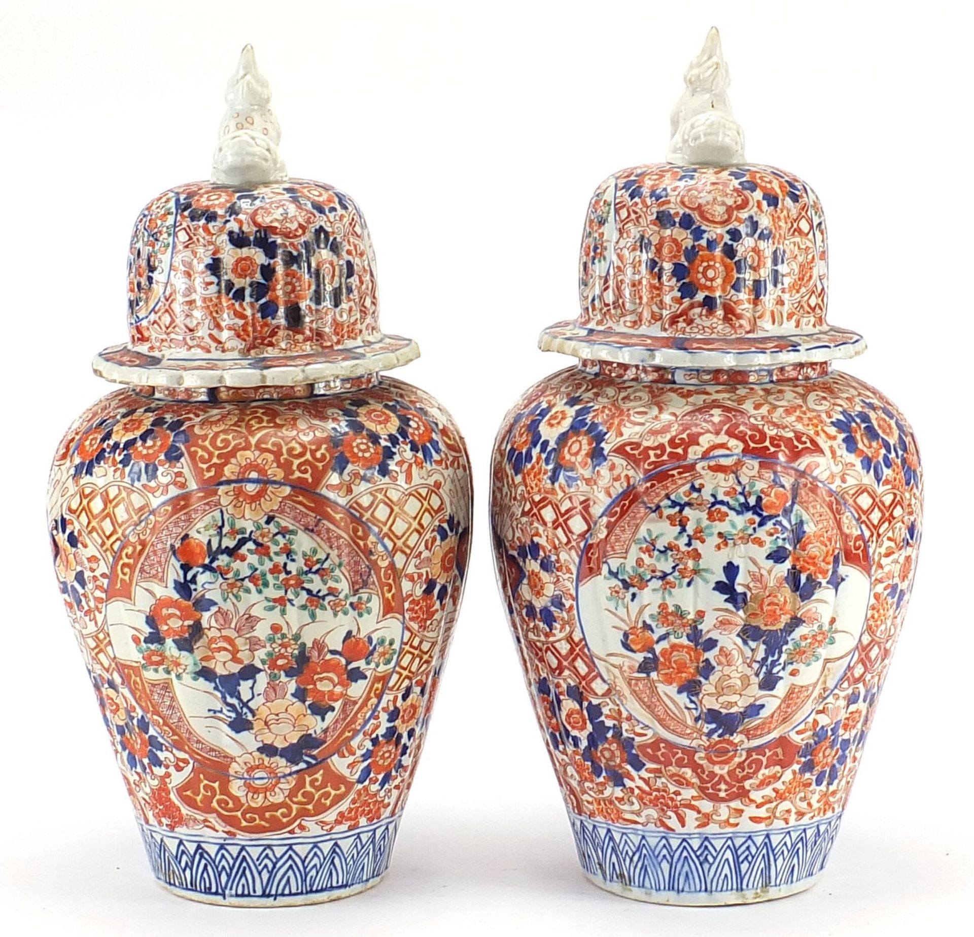 Large pair of Japanese Imari lidded porcelain vases, each profusely hand painted with flowers,