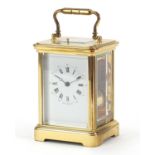 Large brass cased repeating carriage clock striking on a bell with enamelled dial having Roman and