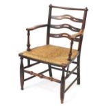 Antique beech and elm open armchair with wavy ladderback and rush seat, 82cm H x 56cm W x 45cm D :