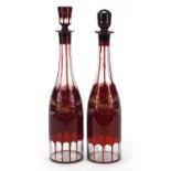 Pair of Bohemian ruby flashed glass decanters etched with leaves and berries, 37.5cm high :For