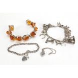 Silver jewellery comprising an amber bracelet, charm bracelet with charms and two love heart