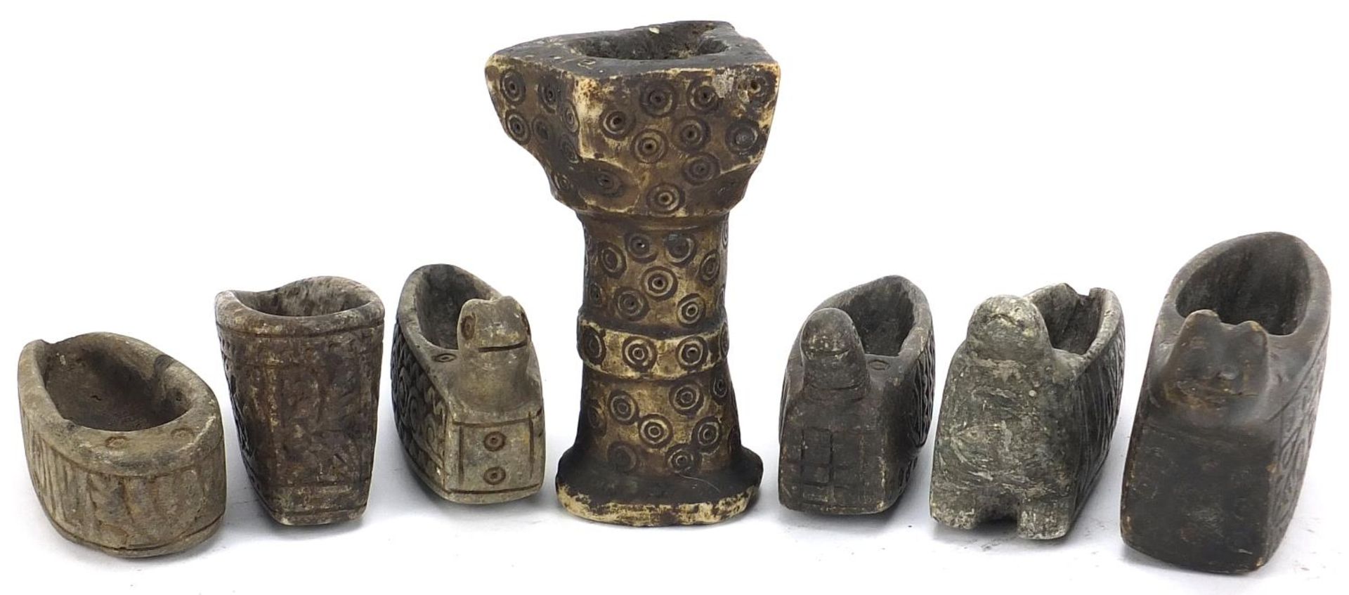 Seven Islamic carved stone oil lamsp including four in the form of birds, 14cm high :For Further