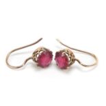 Pair of 9ct gold red stone solitaire earrings, 7mm in diameter, 1.0g :For Further Condition