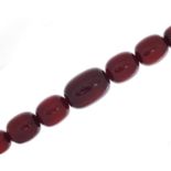 Very large cherry amber coloured bead necklace, the largest bead 4cm in length, 50cm in length,