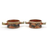 Pair of studio pottery twin handled bowls hand painted with hogs and fish, painted marks to the