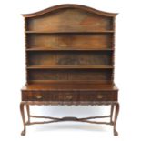 Jonker of Knysna, South African stinkwood dresser with open plate rack above three drawers, on