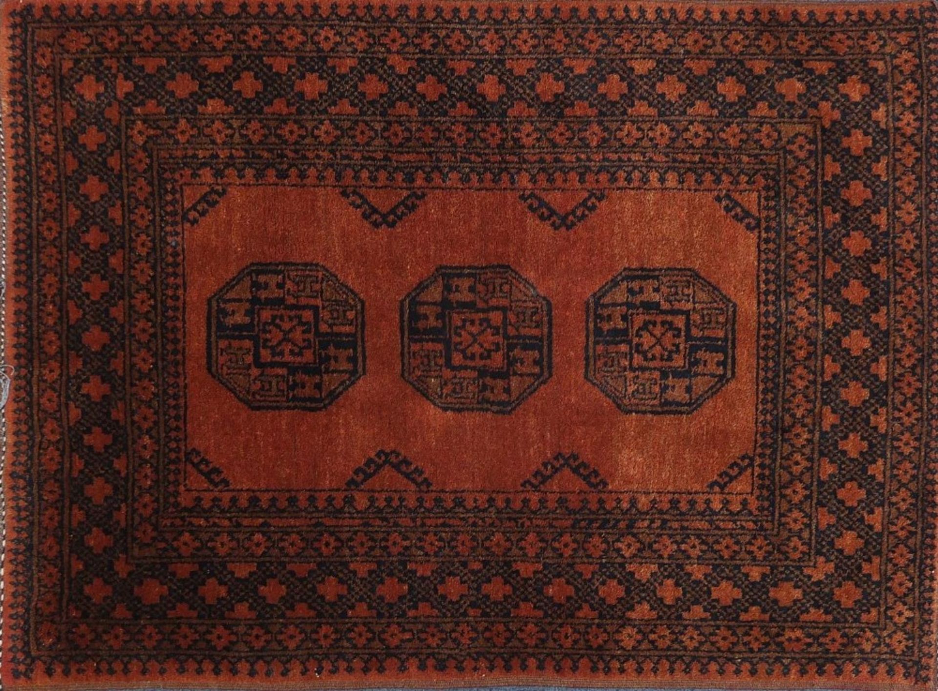 Rectangular Persian orange ground rug having all over geometric design, 148cm x 107cm :For Further