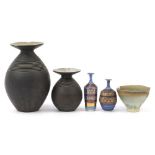 Contemporary studio pottery comprising two large disc top vases, two vases with gilt decoration