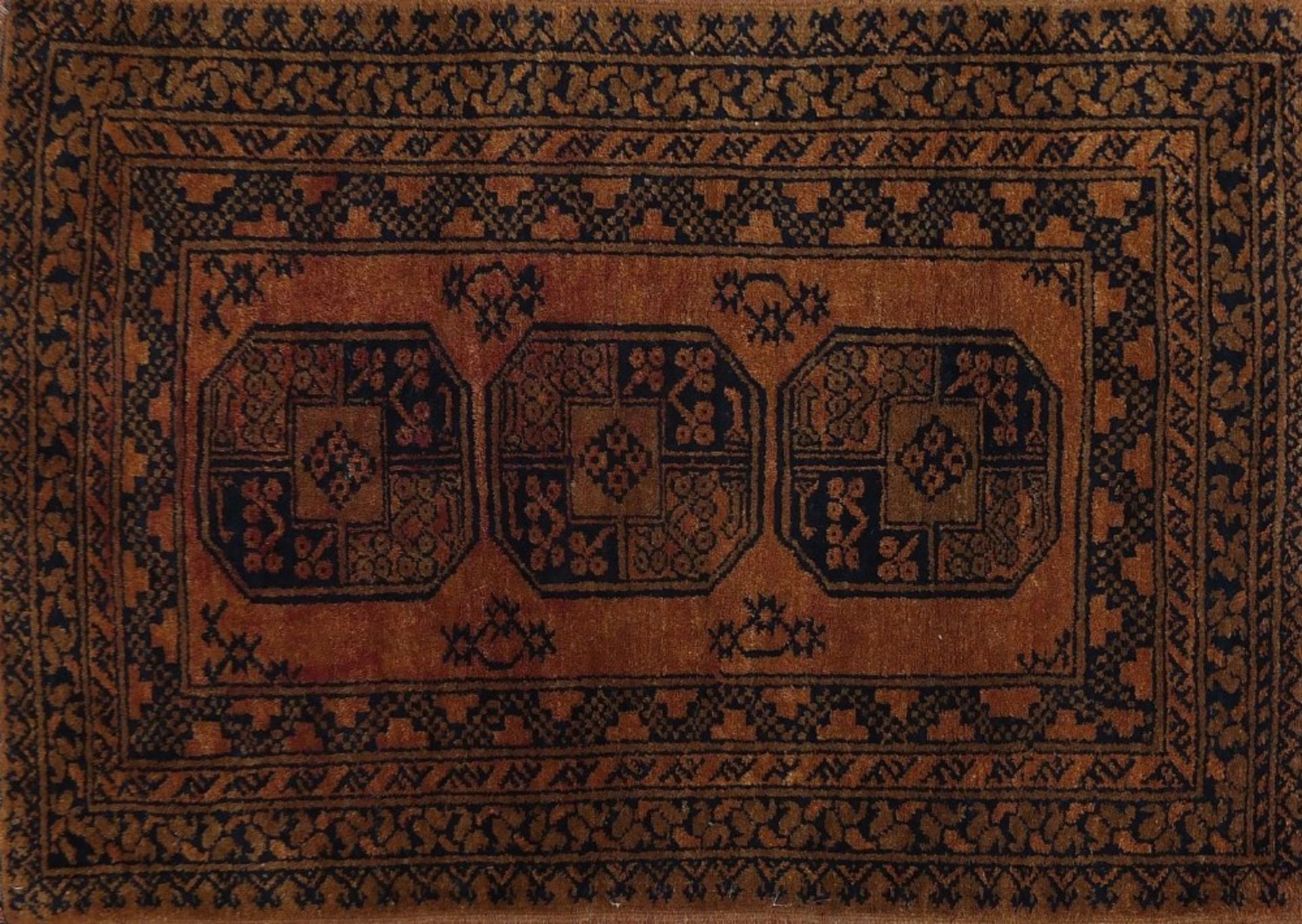 Rectangular Persian orange ground rug having all over geometric design, 125cm x 79cm :For Further