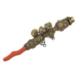 Victorian silver gilt babies rattle whistle with coral teether, indistinct hallmarks, 15cm in
