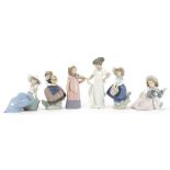 Six Lladro and Nao figurines including one of a young girl playing a violin, the largest 22cm