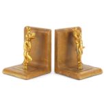 Pair of tooled leather and gilt metal Putti design bookends, each 17cm high :For Further Condition