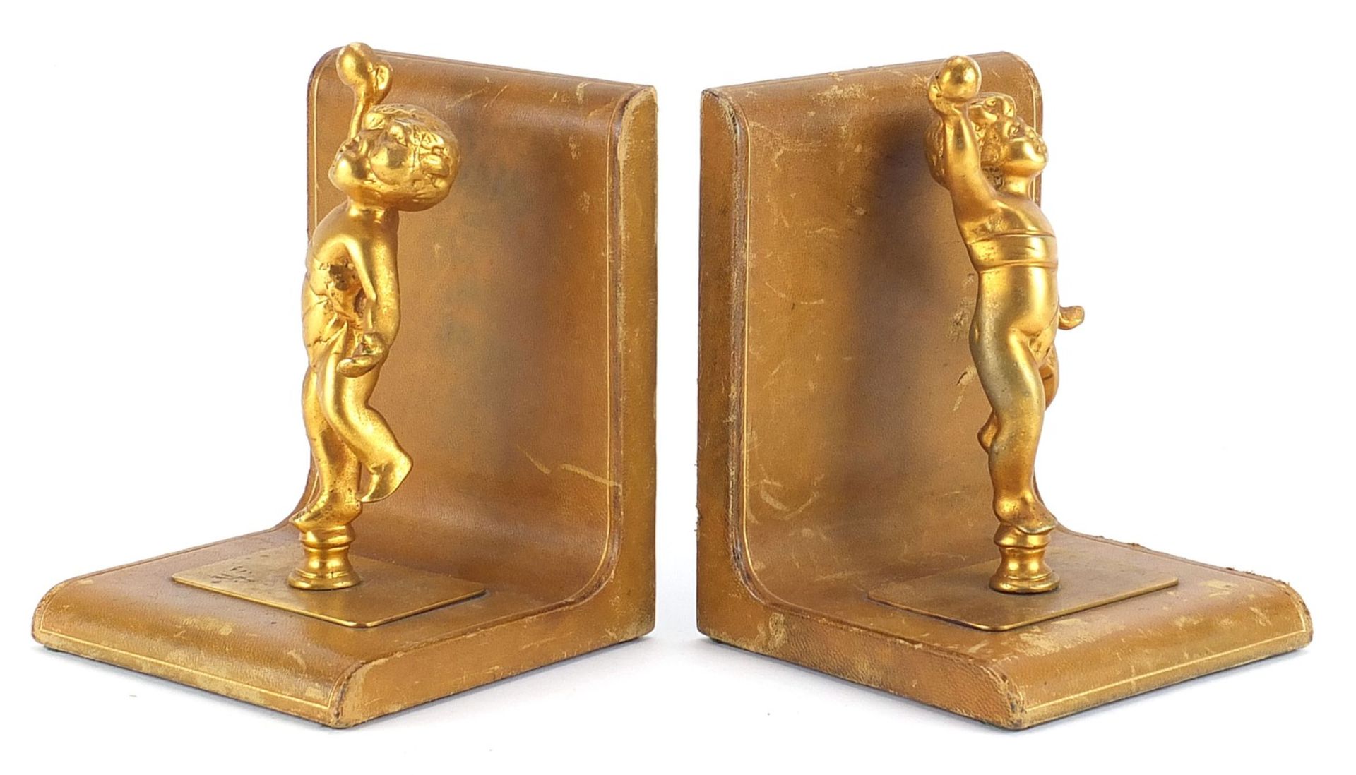 Pair of tooled leather and gilt metal Putti design bookends, each 17cm high :For Further Condition