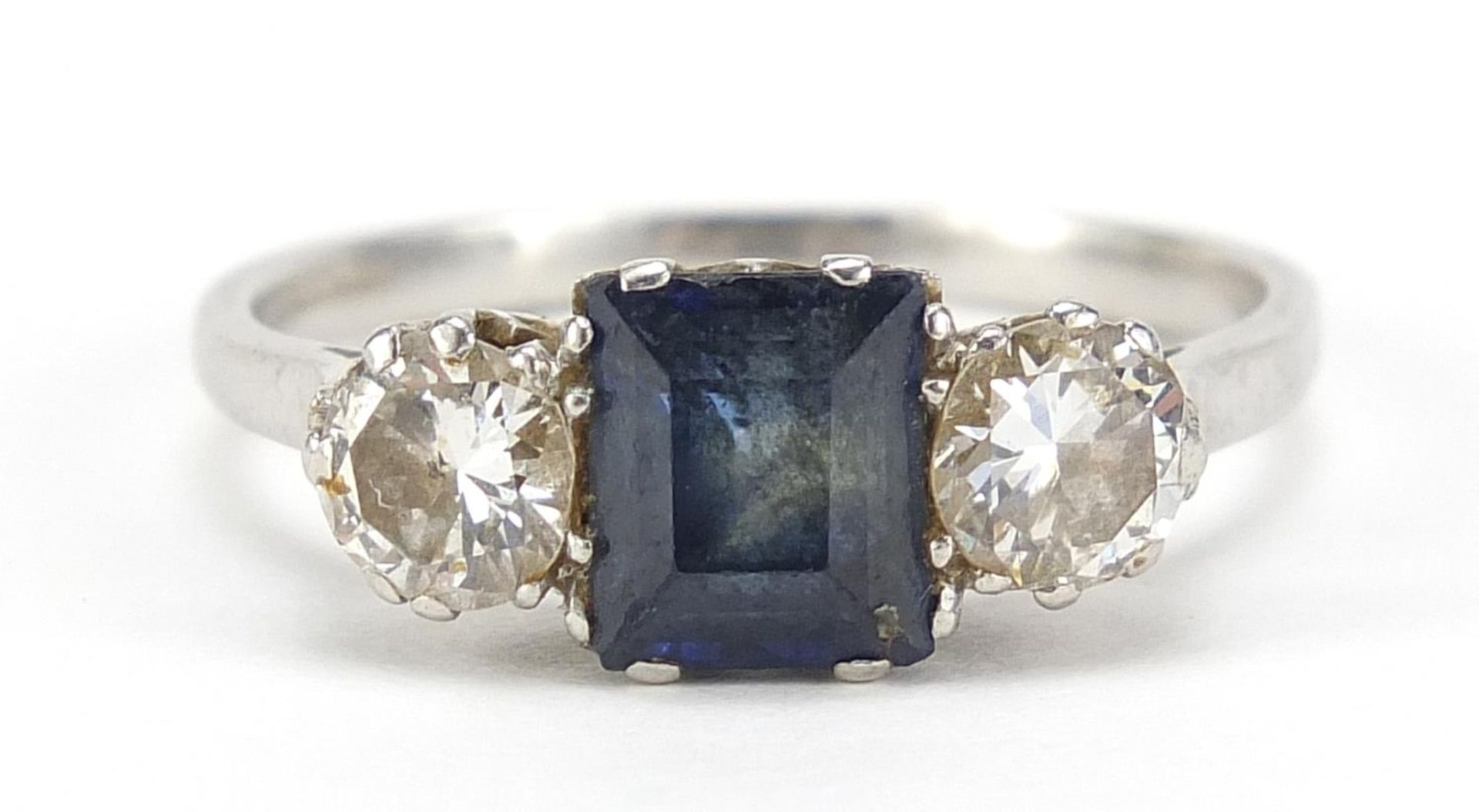 Unmarked platinum sapphire and diamond ring, the sapphire approximately 6.4mm x 5.0mm, the