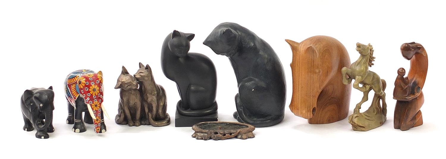 Animal sculptures including a carved wood horse head, carved ebony elephant, bronzed cat and Chinese