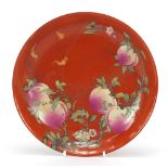 Chinese porcelain iron red ground dish hand painted with three bats amongst peaches and flowers, six