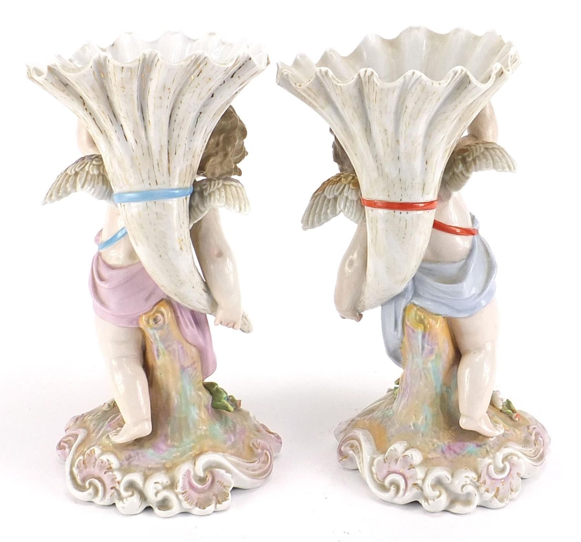 Pair of Continental porcelain Putti and cornucopia design spill vases with floral encrusted bases, - Bild 2 aus 5