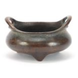 Chinese patinated bronze tripod censer with twin handles, character marks to the base, 8cm wide :For