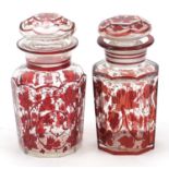 Matched pair of Bohemian glass jars and covers decorated in ruby with foliage, the largest 16cm high