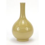 Large Chinese porcelain bottle vase having a yellow glaze, six figure character marks and paper