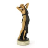 Art Deco style bronzed and ivorine figurine of a scantily dressed female raised on a circular onyx