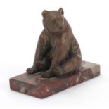 Art Deco patinated bear design desk weight raised on a rectangular marble base, 13.5cm in length :