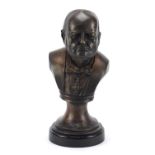 Military interest bronze bust of Winston Churchill raised on a circular ebonised base, 33cm high :