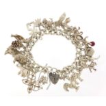Silver charm bracelet with a selection of mostly silver animal charms including bull, elephant,