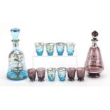 Vintage silver overlaid glass liqueur sets comprising two decanters and ten glasses, the largest