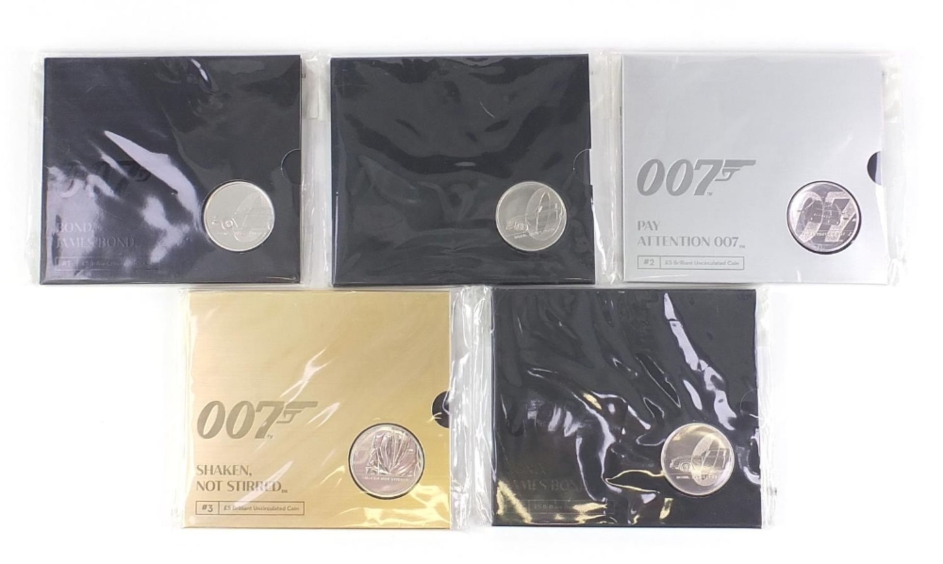 Five James Bond 007 uncirculated five pound coins including The James Bond Collection :For Further