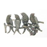 Silver marcasite brooch in the form of birds seated on a branch set with ruby eyes and flowers,