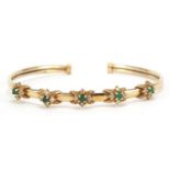 9ct gold green and clear stone bangle housed in a IK Collection box, 6.5cm wide, 8.9g :For Further