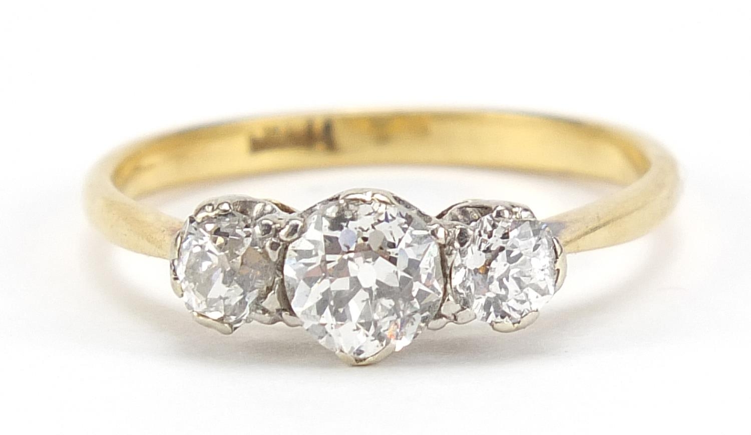 18ct gold diamond trilogy ring, the central diamond approximately 4.7mm in diameter, the smaller