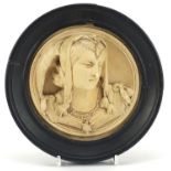 Classical plaster relief plaque of a maiden housed in an ebonised frame, overall 16cm in diameter :