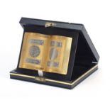 Islamic gilt and silvered metal book design plaque with case, 10cm wide :For Further Condition