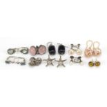 Ten pairs of earrings including some silver set with semi precious stones including amber, pearls
