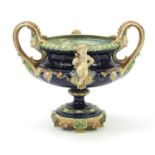 19th century Majolica centrepiece with twin handles surmounted with two Putti, 27.5cm high x 33.