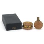 Antique cranberry glass scent bottle and compact with brass foliate overlay housed in a silk lined