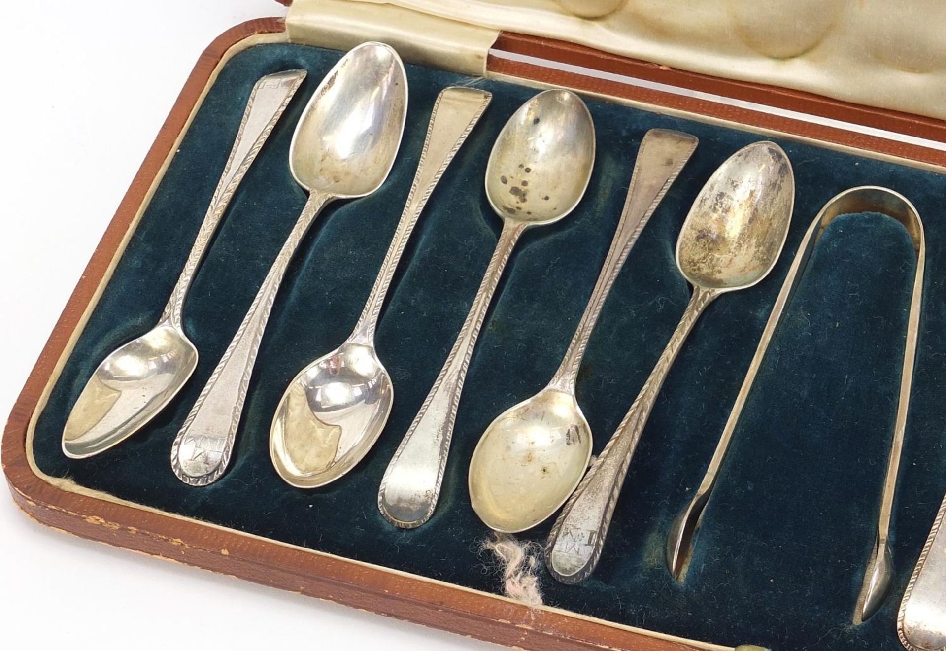 Matched set of twelve silver teaspoons and silver plated sugar tongs housed in a velvet and silk - Image 2 of 6