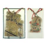 Two Chinese vellum theatre shadow puppets of dragons, each housed in a glass hanging frame, the